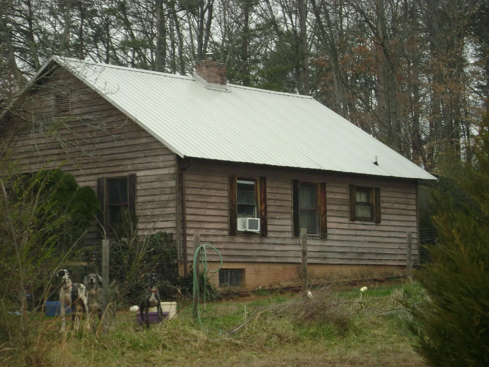 White metal roof on an old wood sided farmhouse, from a Metal Roof Installation job in Saint Clair